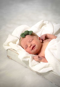 High angle view of baby boy sleeping on bed at home