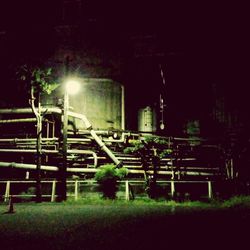 Illuminated railroad tracks at night