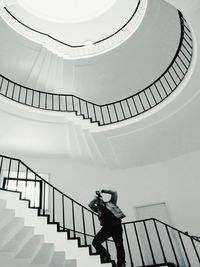 Woman standing on escalator