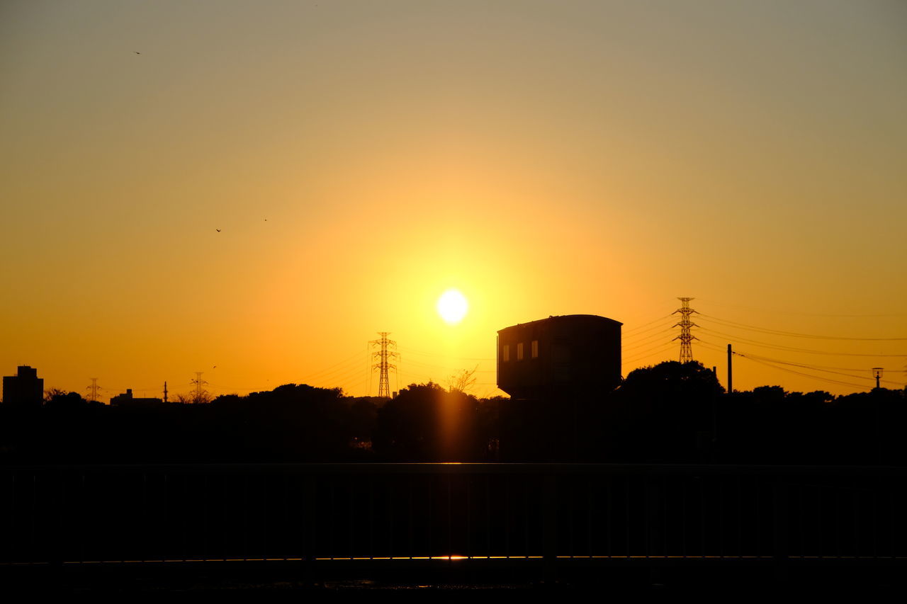 sunset, sky, silhouette, afterglow, architecture, built structure, orange color, sun, nature, dawn, building exterior, city, horizon, no people, beauty in nature, sunlight, evening, outdoors, building, skyline, landscape, tranquility, red sky at morning, scenics - nature, cloud, copy space, water