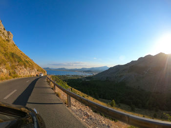 Road amidst mountains against sky