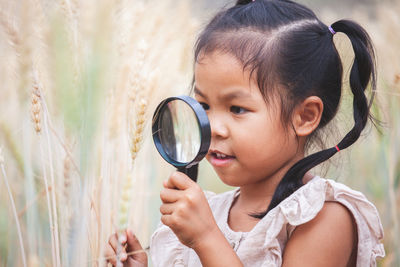 Girl playing in wheat field