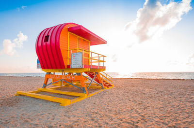 Lifeguard hut on beach against sky