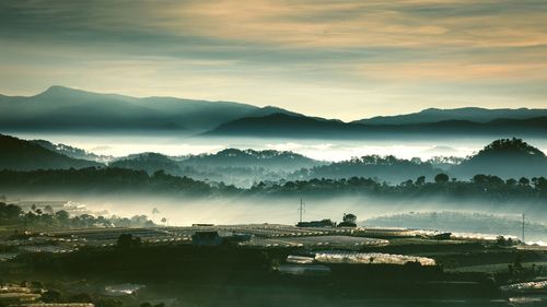 Scenic view of lake and mountains against sky