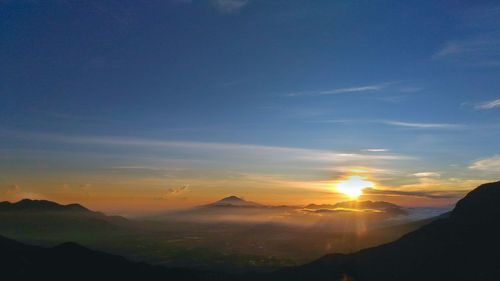 Scenic view of silhouette mountains against sky during sunset