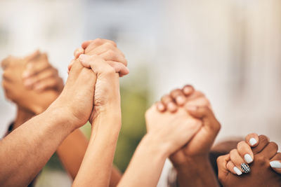 Cropped image of people stacking hands