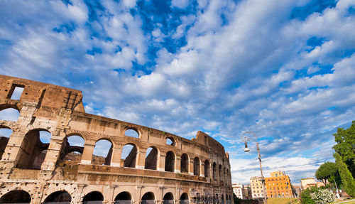 Low angle view of historical building against cloudy sky