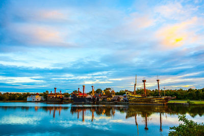 Reflection of buildings in lake against sky