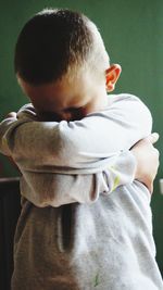 Rear view of boy standing outdoors