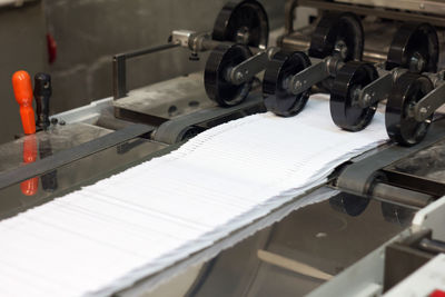 Close-up of papers on conveyor belt