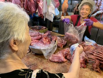 Woman buying meat at market