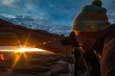 Man photographing at sunset