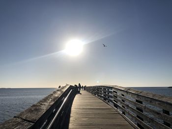 Pier over sea against clear sky