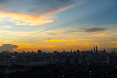 Cityscape against sky during sunset