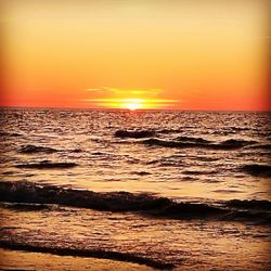 Scenic view of sea against romantic sky at sunset