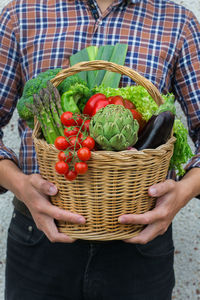 Midsection of woman holding wicker basket