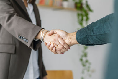 Recruiter shaking hand with candidate in office