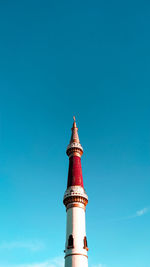 Low angle view of bell tower against blue sky