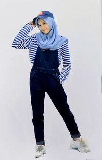 Boy standing against white background