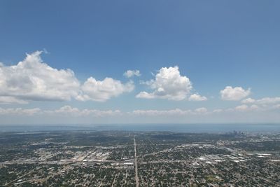 Aerial view of buildings in city against sky