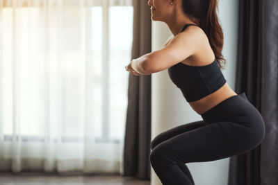 Young woman exercising at home