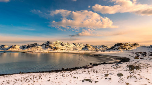 Scenic view of snowcapped mountains against sky during sunset