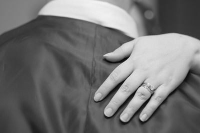 Cropped hand of bride on groom