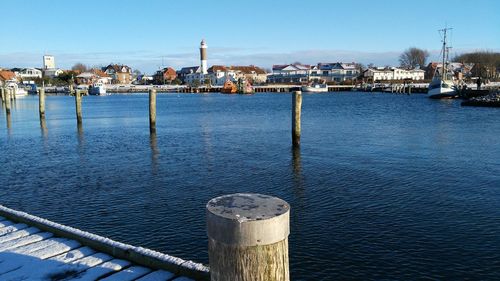 Houses at waterfront against sky