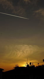 Silhouette built structure against sky during sunset