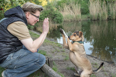 Man doing high five with dog