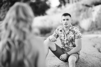 Portrait of couple sitting outdoors