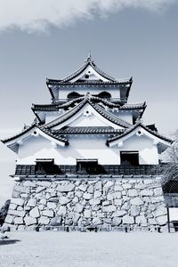 Low angle view of building against sky during winter