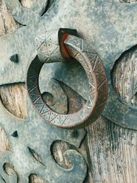 Close-up of old rusty chain on wood