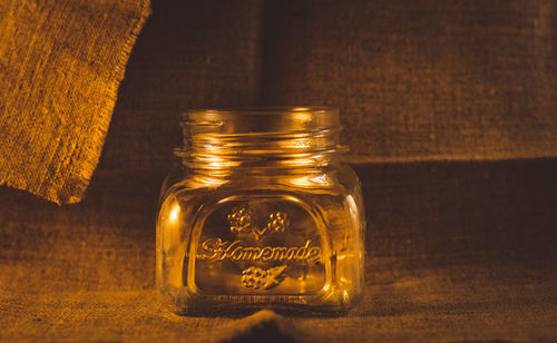 Close-up of glass jar on fabric