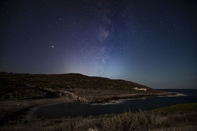 Scenic view of mountains against sky at night