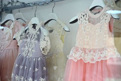 Colorful dresses hanging at store for sale