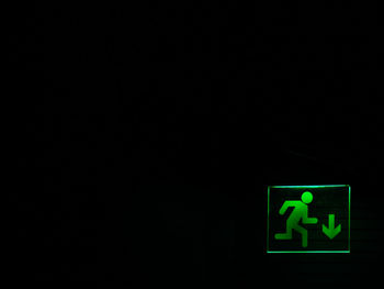 Close-up of illuminated lights over black background