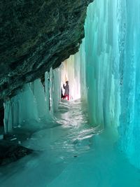 Friends standing in ice cave