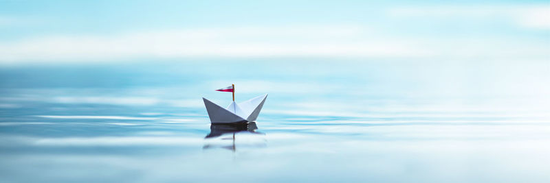 Sailboat sailing on sea against sky