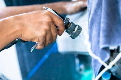 Cropped image of man repairing car