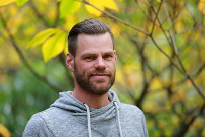 Portrait of young man against plants