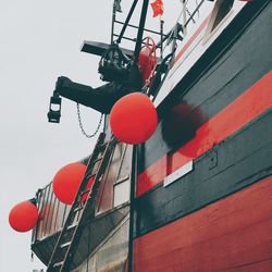 Low angle view of red lights hanging on building