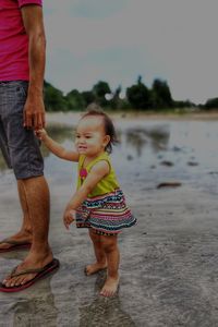 Mother and son standing in water