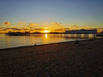 Scenic view of beach against sky during sunset