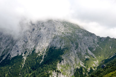 Scenic view of mountains against cloudy sky