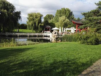 Scenic view of river against cloudy sky