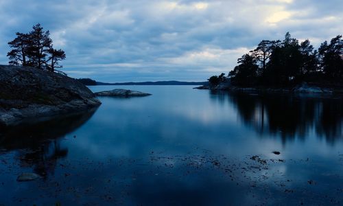 Scenic view of lake against sky at sunset