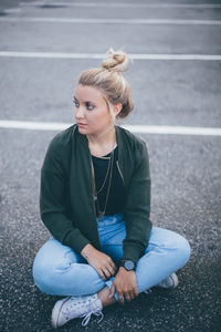 Portrait of woman sitting on road