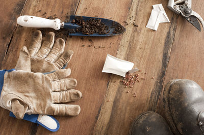 Directly above shot of gardening equipment with gloves and shoes