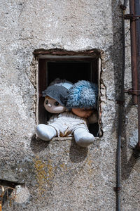 View of stuffed toy against wall in old building